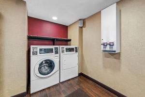 a laundry room with a washer and dryer at Red Roof Inn Columbus West - Hilliard in New Rome
