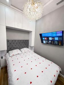 a bedroom with a bed with red hearts on it at Nest one, Tashkent City in Tashkent +5 photos
