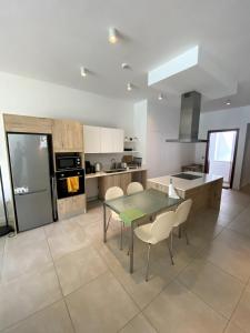 a large kitchen with a table and chairs in it at Seaside Escape with Breathtaking View in Grand Gaube