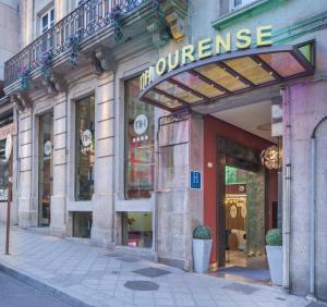 a store front with a sign that reads the twenties at NH Ourense in Ourense
