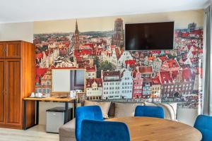 a living room with a wall mural of a city at Royal Rooms in Gdańsk