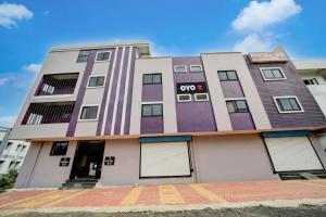 a building with purple and white paint at Hotel O G9 in Akolia +23 photos