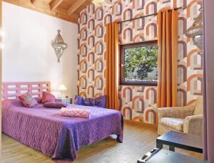 a bedroom with a purple bed and a window at Chambre D'hôtes Naturistes Nudistes in Monte da Charneca +20 photos