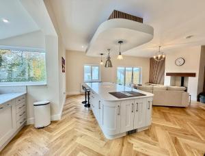 a kitchen with a large white island in a room at Jaytrees, Keswick - Luxury bungalow with hot tub in Keswick +21 photos