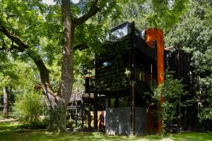 a tree house in the middle of a park at Zero Zero Treehouse in Coleford