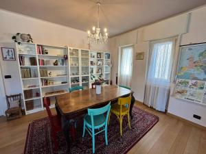a dining room with a table and chairs and bookshelves at Il Nido di Adele in Sernio +13 photos