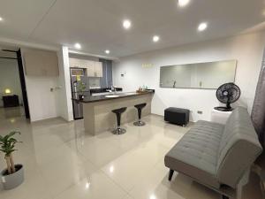 a living room with a desk and a bar in it at Casa 106 - Apartaestudios in Cali +20 photos