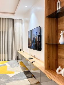 a living room with a television on a wall at Tranquil Ridge BnB in Blantyre