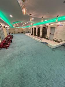 a large room with green lights on the ceiling at Marriot Palace Hotel Free Shuttle Service to Haram - فندق قصر ماريوت توصيل مجاني للحرم in Al ‘Azīzīyah