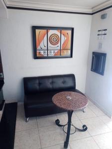 a living room with a couch and a table at motel alamo in Guadalajara