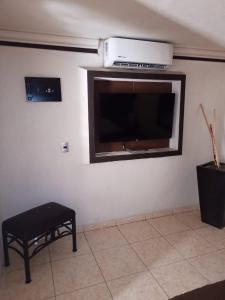 a living room with a flat screen tv on the wall at motel alamo in Guadalajara