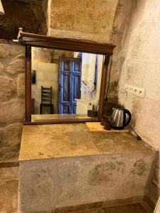 a window in a stone room with a door at Cosy cave suit in Urgup