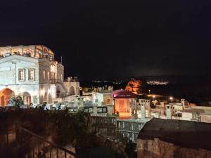 a large building at night with lights on at Cosy cave suit in Ürgüp +10 photos