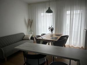 a living room with a table and a couch at Penthouse Apartment in Gießen
