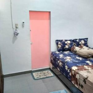 a door in a room with a couch and a red door at Dulcon278 in Sukarami