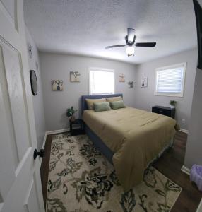 a bedroom with a bed and a ceiling fan at Little House in Indy sleeps many in Indianapolis