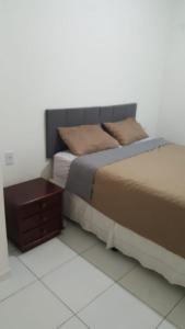 a bedroom with a bed and a night stand at Casa Machado in Conde