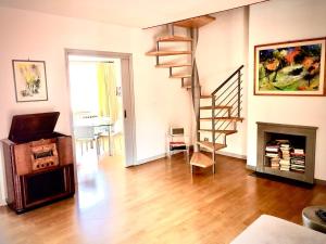 a living room with a staircase and a fireplace at Private terrace penthouse with elevator Piazza Spagna in Rome