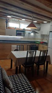 a kitchen with a table and chairs in a kitchen at Plaza Consistorial in Pamplona