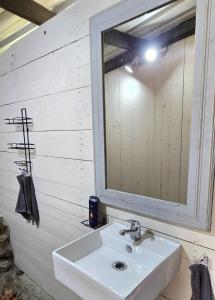 a bathroom with a sink and a mirror at Glamping tent in Nelspruit