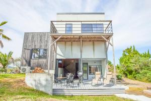 a house with a deck with chairs on it at COCO VILLA 九十九里一宮-Sauna- in Ichigaya
