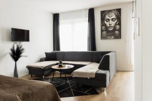 a living room with a couch and a table at Dream Premium Apartman in Mosonmagyaróvár