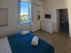 a bedroom with a blue bed with towels on it at Acquamarina in Sant'Agnello