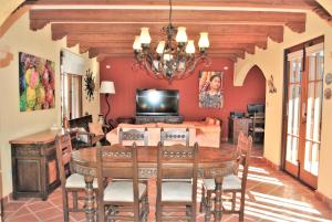 a dining room with a table and a television at Casa Mar de Cortez in Loreto