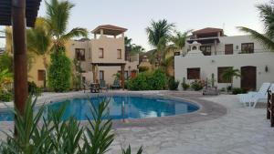 a swimming pool in front of a house at Casa Mar de Cortez in Loreto