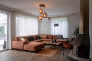 a living room with a brown couch and a table at Puur17 in Lommel