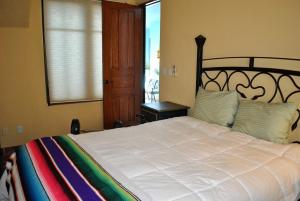 a bedroom with a large bed and a window at Casa Mar de Cortez in Loreto +24 photos