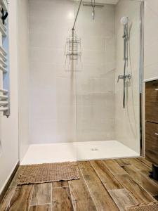 a bathroom with a shower with a glass door at La Parent-aise in Thionville
