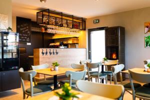 a restaurant with tables and chairs and a counter at Husí plácek s vinným sklepem a terasou in Dolní Věstonice