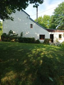 a large white house with a yard with chairs at Nice ground floor with garden for 2 people 