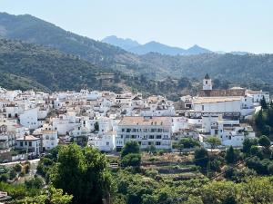 a group of white buildings on a hill with mountains at Casa Wenne - Private Pool with view in Sedella