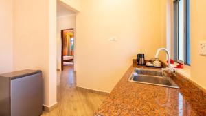 a kitchen with a sink and a counter top at Coconut Breeze Apartments in Kiwengwa