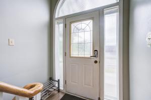 a white door in a hallway with a window at Nest in the Orchard--cozy room in Toronto +6 photos