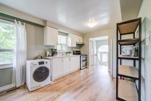 a kitchen with a washer and dryer in it at Nest in the Orchard--cozy room in Toronto