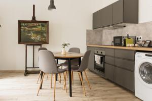 a kitchen with a table and chairs in a kitchen at Dream Apartman in Levél