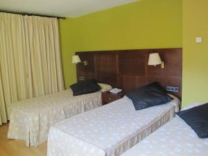 Postel nebo postele na pokoji v ubytování Hotel De Rei