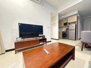 a living room with a large flat screen tv at Colombo Stay - Skyview Retreat in Colombo