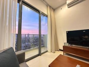 a living room with a large view of a city at Colombo Stay - Skyview Retreat in Colombo +16 photos