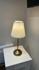 a lamp sitting on top of a white table at 77 Lovely Self-Contained Studio Easy Access to Central London in Northolt
