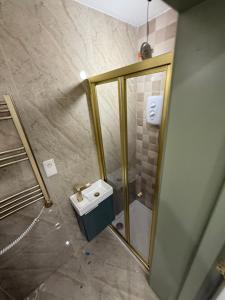 a bathroom with a shower and a toilet and a sink at 77 Lovely Self-Contained Studio Easy Access to Central London in Northolt