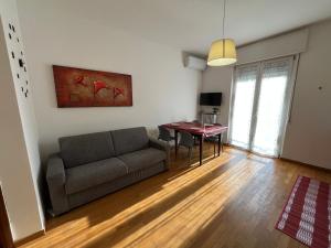 a living room with a couch and a table at GIODE X Borgo Roma II in Verona