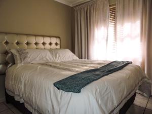 a bed with a blanket on it in a bedroom at Poplar place Thornton in Cape Town