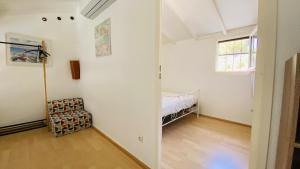 an empty room with a bed and a window at Maison la pinède in Oignies