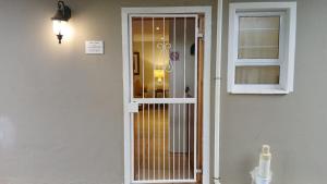 a door to a room with a window at Dayspring Cottage in Howick