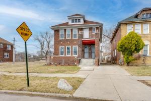 a street hump sign in front of a brick house at Pet-Friendly Detroit Stay Near Motown and DIA in Detroit +16 photos
