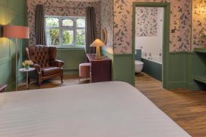 a bedroom with a bed and a chair and a window at Brackenborough Hotel, BW Signature Collection in Louth +117 photos
